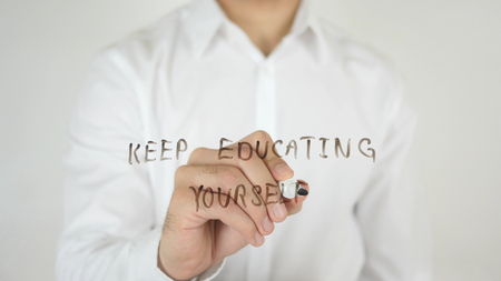 Keep Educating Yourself, Written on Glass by Man in Studioの写真素材