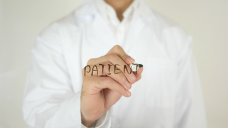 Patient, Written on Glass by Doctor in Studioの写真素材