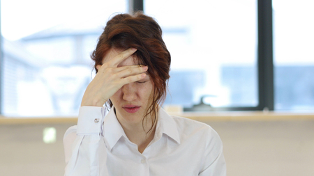 Headache, Tired Upset Woman in Office at Workの写真素材