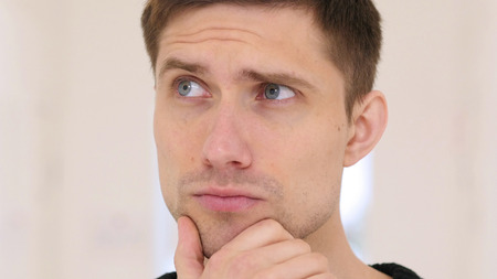 Thinking Pensive Man at work, Close Up at Work in Office