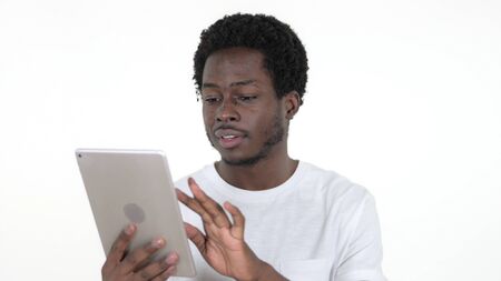 Casual African Man Browsing Interne on Tablet, White Backgroundの写真素材