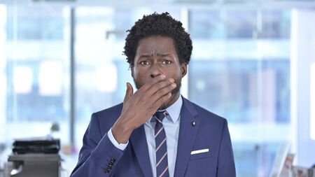 African American Businessman get Shocked and Hand on Mouthの写真素材