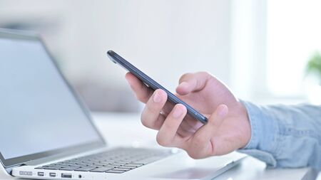 Close Up of Hand using Smartphone in Office
