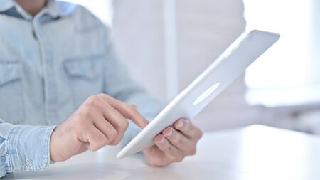 Close Up of Young Guy Hands making Report on Tablet