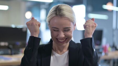 Portrait of Surprised Businesswoman Celebrating Successの写真素材