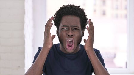 Portrait of Angry Young African American Man Shoutingの写真素材