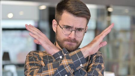 Portrait of Young Designer saying No with Hand Gestureの写真素材