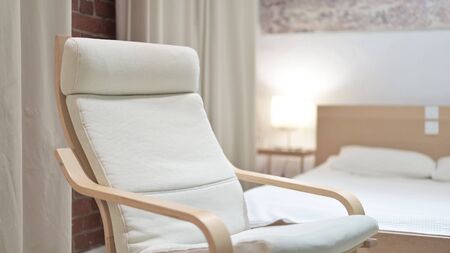 Empty Bedroom with Chair in Focus