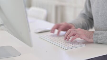 Close Up of Man Typing on Keyboard at Work