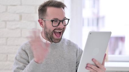 Creative Man Talking for Video Chat on Tabletの写真素材