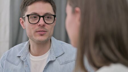 Close up of Cheerful Young Couple having Conversationの写真素材