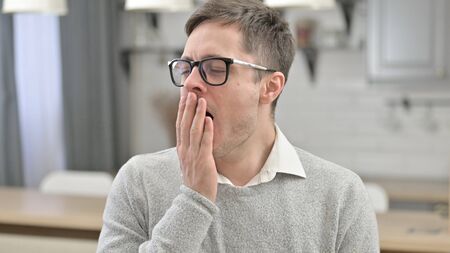 Portrait of Tired Young Man Yawningの写真素材