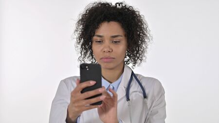 Cheerful African Female Doctor doing Video Chat, White Backgroundの写真素材