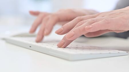Close Up of Woman Hands Typing on Keyboardの写真素材