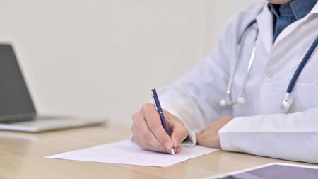 Close up of Doctor Writing on Paperの写真素材