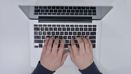Top View of Hands Typing on Laptop