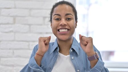 Excited Young African Woman Celebrating Successの写真素材
