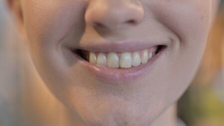 Close up of Smiling Young Woman Lips and Teeth