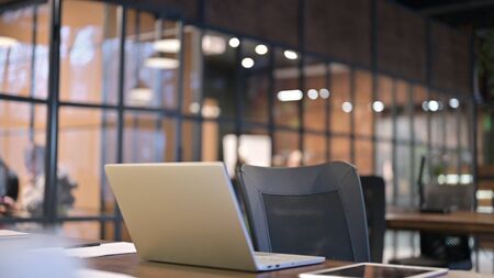 Empty Office with Laptop on Tableの写真素材