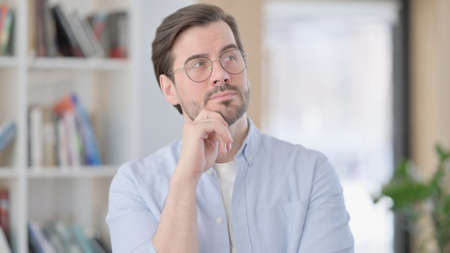 Portrait of Pensive Man in Glasses Thinking