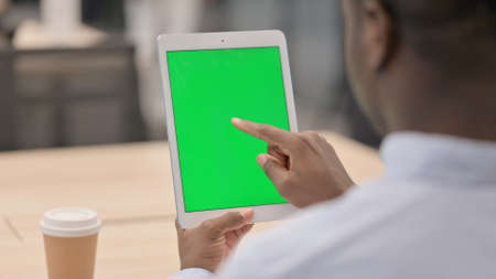 African Businessman using Tablet with Chroma Screen