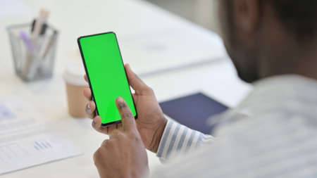 African Man using Smartphone with Green Chroma Screen