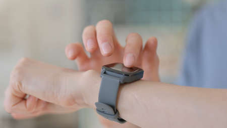 Close up of Hands of Young Woman using Smartwatch