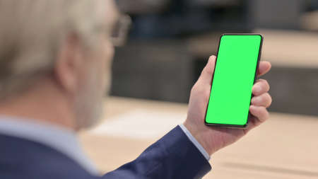 Male Doctor using Smartphone with Chroma Screenの写真素材