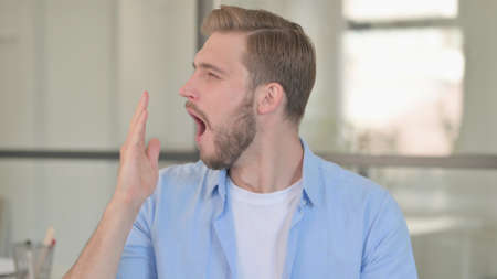 Portrait of Sleeping Young Man Yawning