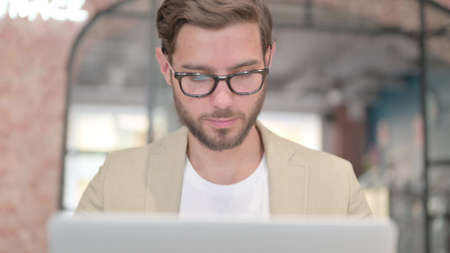 Close Up of Man Working on Laptop