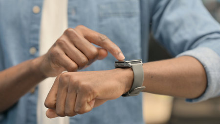 Hands of African Man using Smartwatch