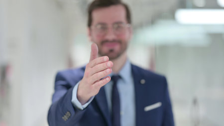 Portrait of Young Businessman offering Hand Shakeの写真素材