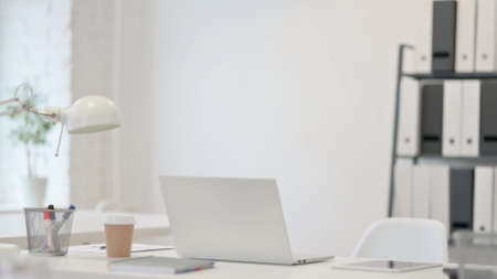 Minimalist Office with Open Laptop on Deskの写真素材
