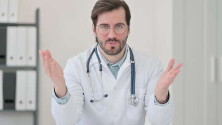 Portrait of Young Doctor Talking on Video Callの写真素材