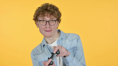 Excited Man Playing Video Game, Yellow Background