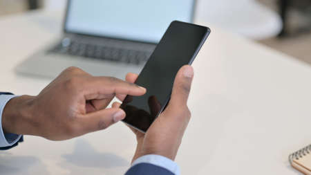Hands of African Businessman using Smartphone, Close up