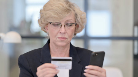 Online Shopping on Smartphone by Old Businesswomanの写真素材