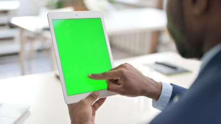 African Businessman using Tablet with Green Chroma Key Screenの写真素材