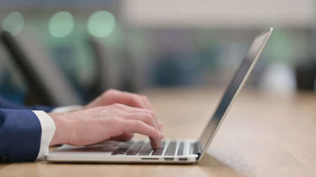 Close up of Businessman Hands Typing on Laptop