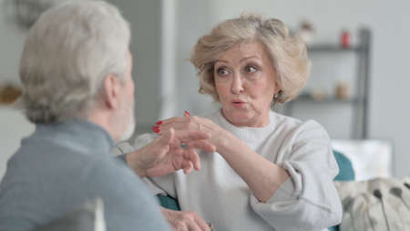 Old Couple having Conversation on Sofaの写真素材