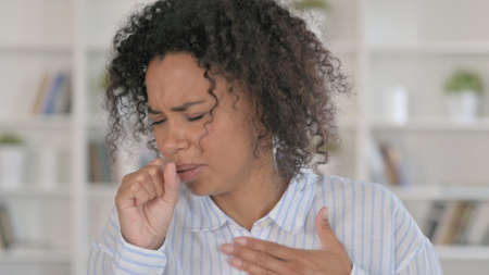 Portrait of Coughing Sick African Businesswomanの写真素材