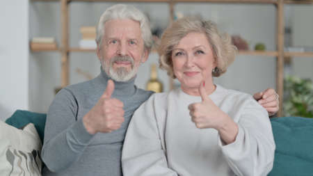 Positive Old Couple showing Thumbs Up, Home