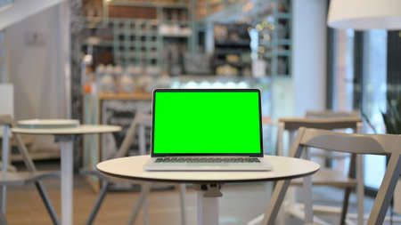 Laptop with Green Chroma Key Screen in Cafeの写真素材