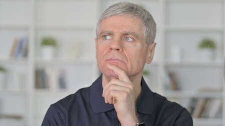 Thoughtful Middle Aged Man Thinkingの写真素材