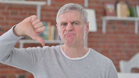 Unhappy Old Man showing Thumbs Downの写真素材
