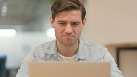 Close up of Shocked Man on Laptopの写真素材
