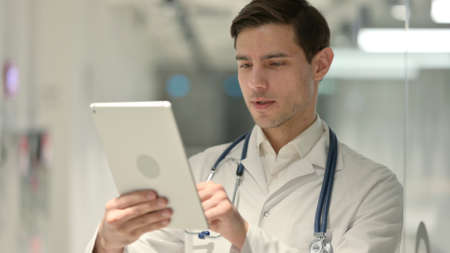 Portrait of Doctor Using Tablet in Officeの写真素材