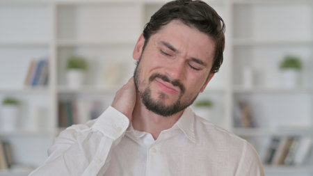 Tired Young Man having Neck Painの写真素材