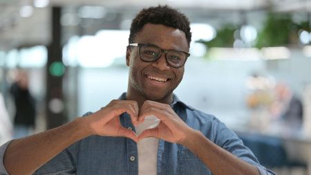 Portrait of African Man showing Heart Shape by Handsの写真素材