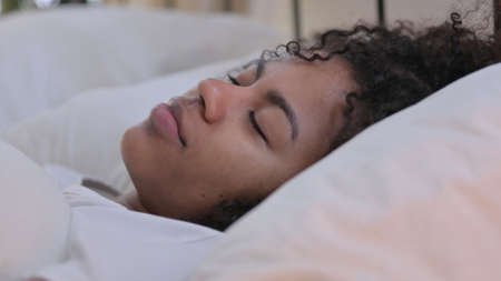 Close up of African Woman Sleeping in Bedの写真素材